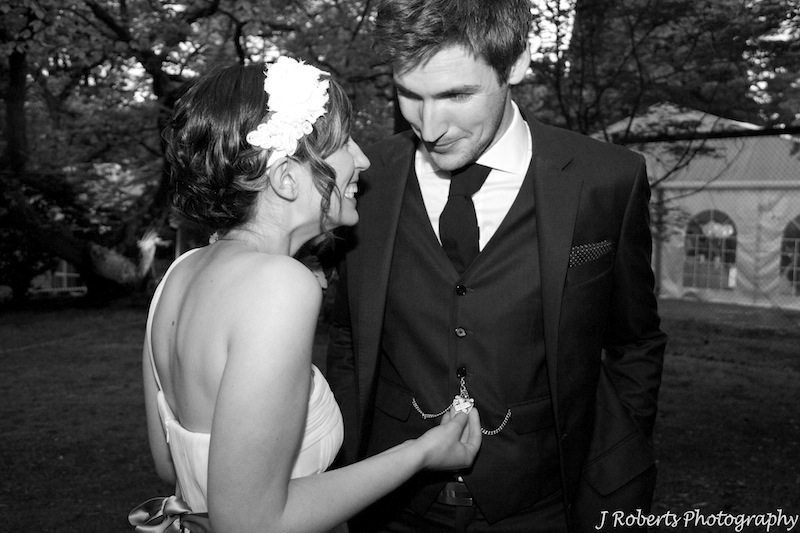 Bride and groom looking at fob watch - wedding photography